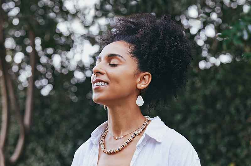 Woman taking a deep breath outside
