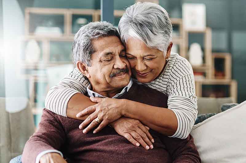 Couple hugging on a sofa