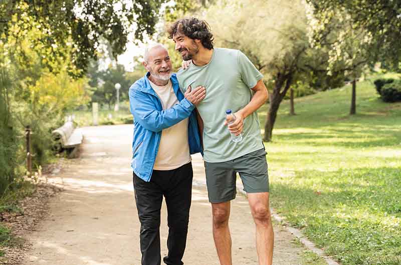 Father and son walking through a park
