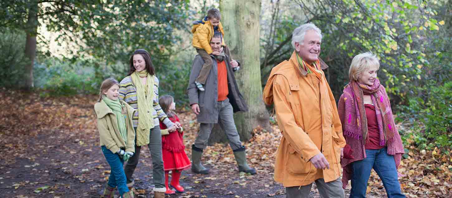A family walking in the woods in autumn
